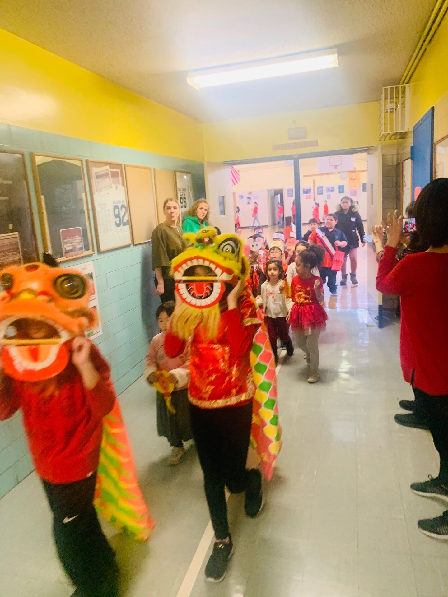 Lunar New Year dragon parade through the school hallway